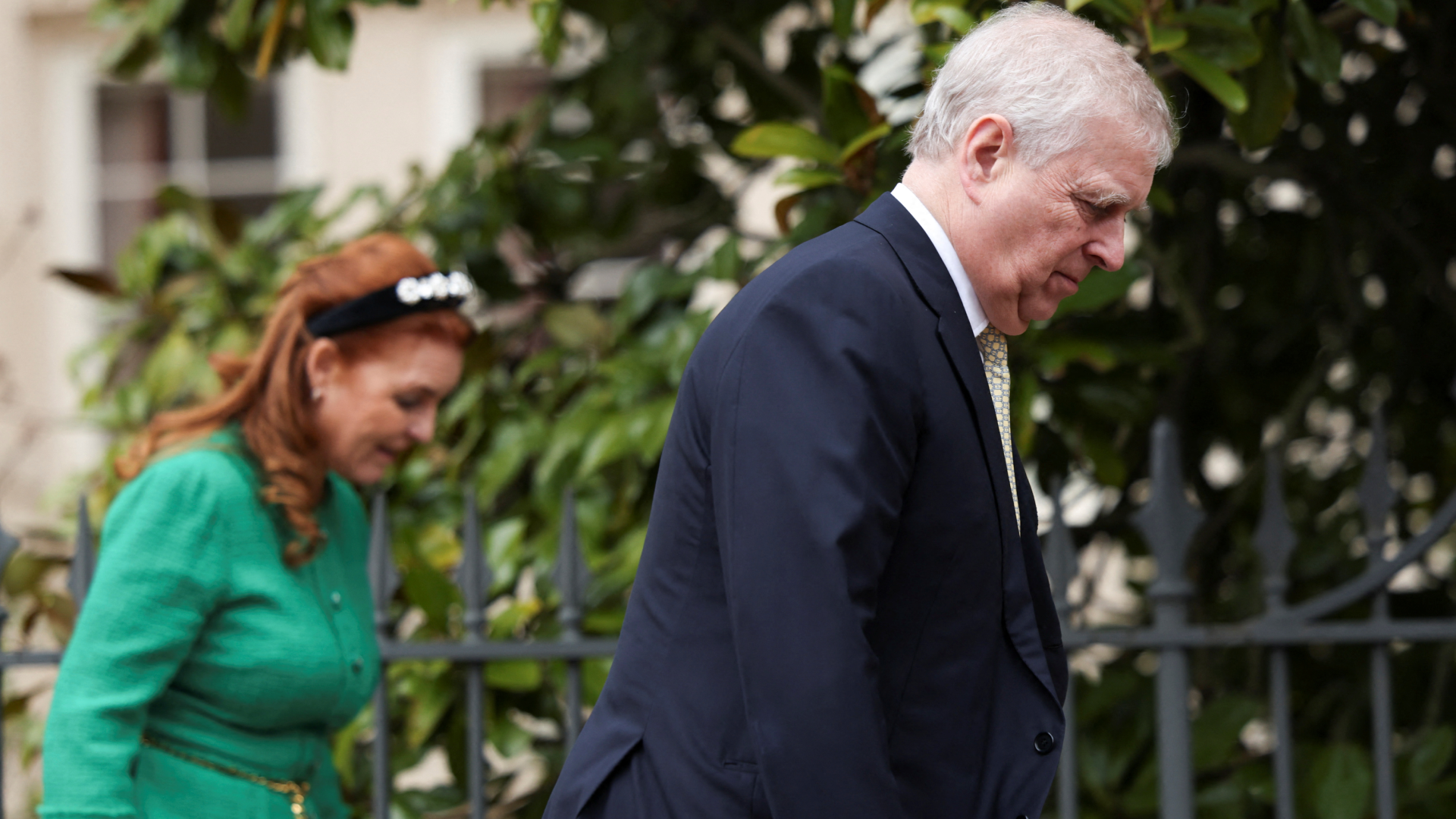 Sarah Ferguson and Prince Andrew walking in front of trees