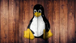 Linux penguin on wood.