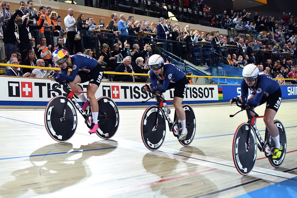 USA's team members cross the finish line to win the women's pursuit final during the UCI Track Cycling World Championships