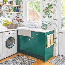 Washing machine built into green cabinets