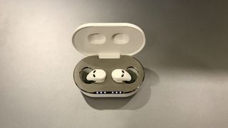 QuietOn 3 earbuds in case, on silver background