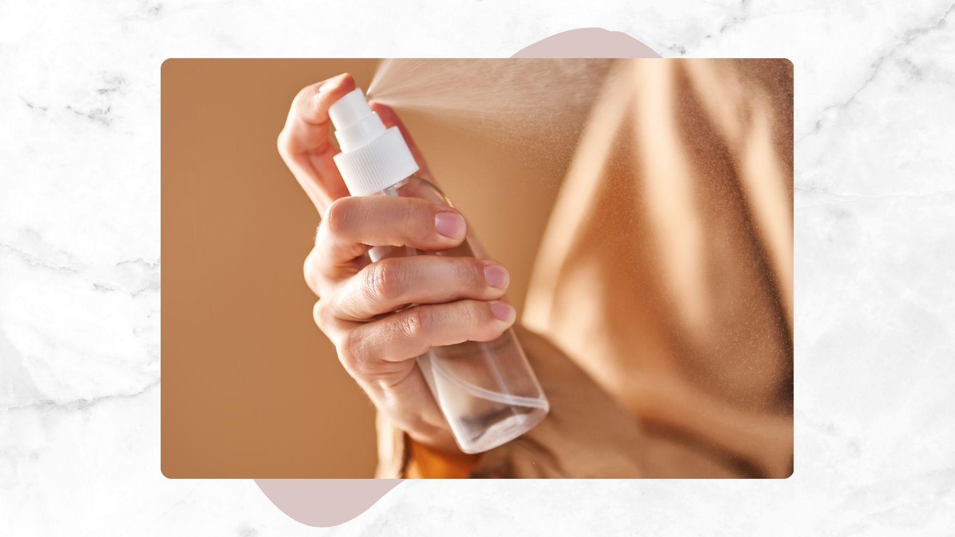 a woman's hand misting a setting spray in a silk shirt on a beige background