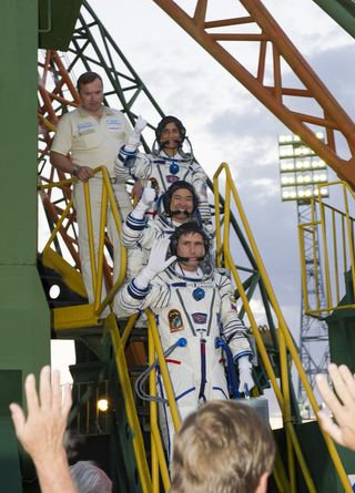 Space Station's Expedition 32 crew waves farewell before launch on July 15, 2012 local time in Baikonur Cosmodrome, Kazakhstan