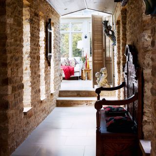 hallway with stone wall and designed seat with cushion