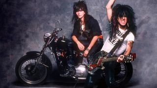 LA Guns: Phil Lewis and Tracii Guns on a bike in 1988