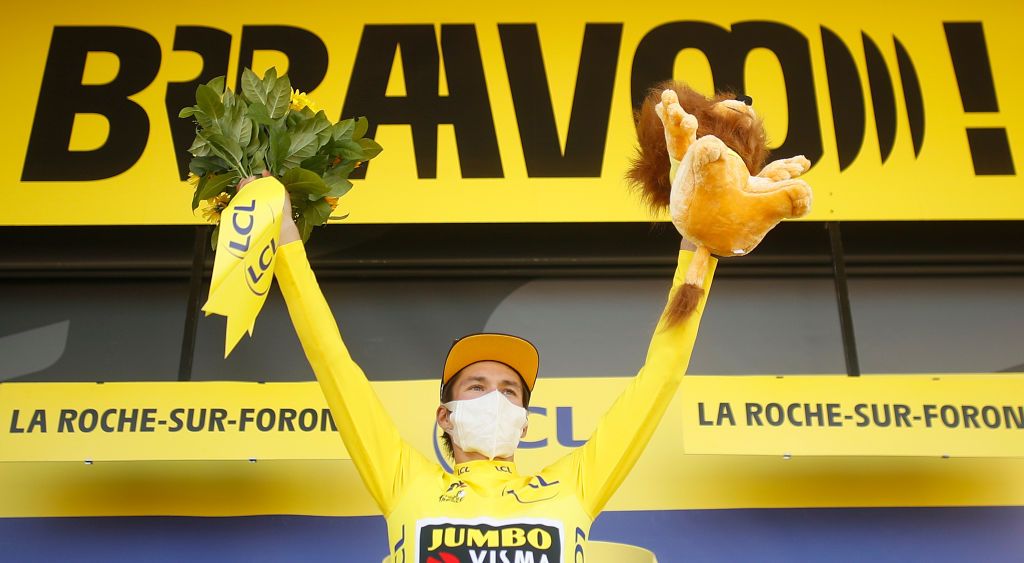Team Jumbo rider Slovenias Primoz Roglic celebrates his overall leader yellow jersey on the podium at the end of the 18th stage of the 107th edition of the Tour de France cycling race 168 km between Meribel and La Roche sur Foron on September 17 2020 Photo by STEPHANE MAHE POOL AFP Photo by STEPHANE MAHEPOOLAFP via Getty Images