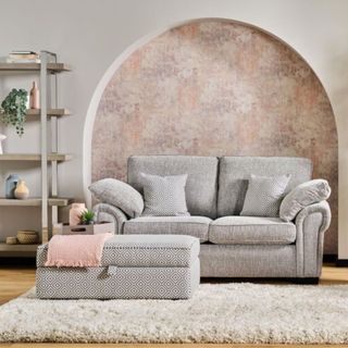A grey fabric sofa in a neutral living room 