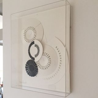 stensil design on white wall and glass frame