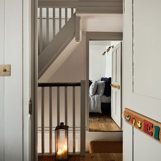 Landing in a three storey house showing the view across from one bedroom to another, as well as the bannister for stairs to the ground and third floors