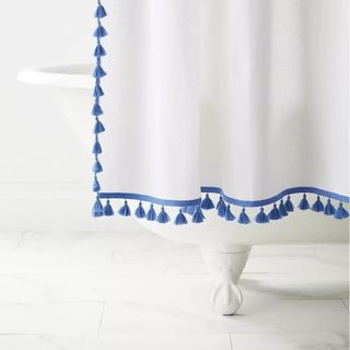 White shower curtain with blue tassel trim
