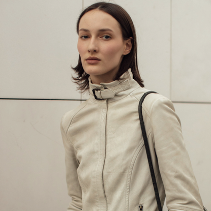 woman wearing a tan jacket