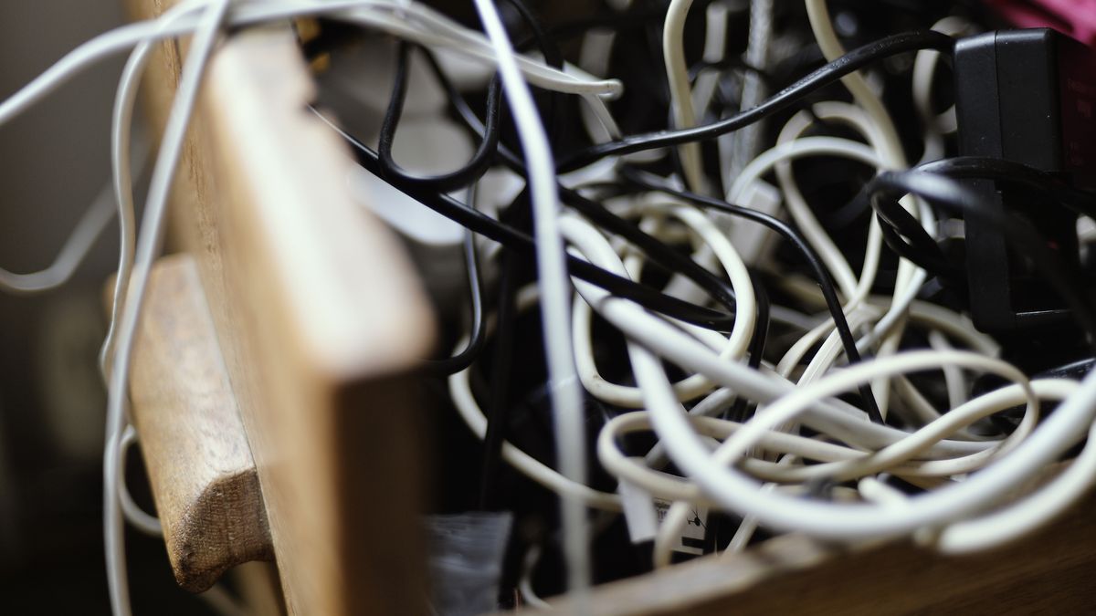 A photograph of a drawer full of tangled cables