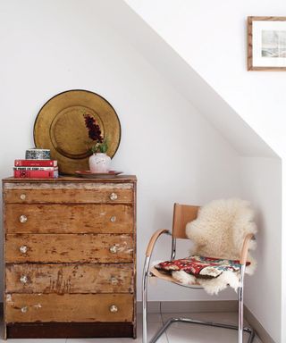 wooden chest of drawers with armchair