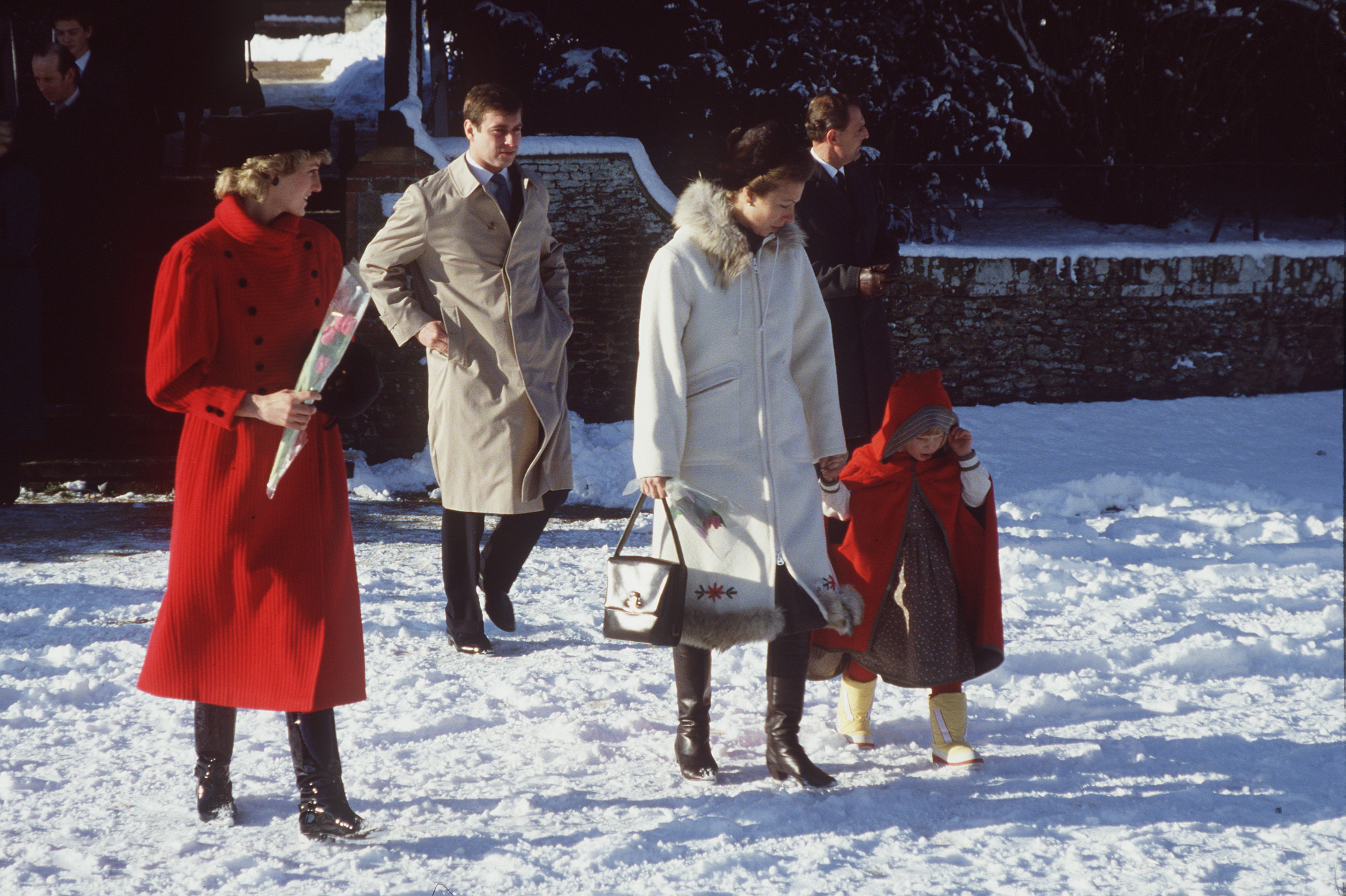 Princess Diana, Prince Andrew, Princess Anne and Zara Phillips walking through snow in 1985