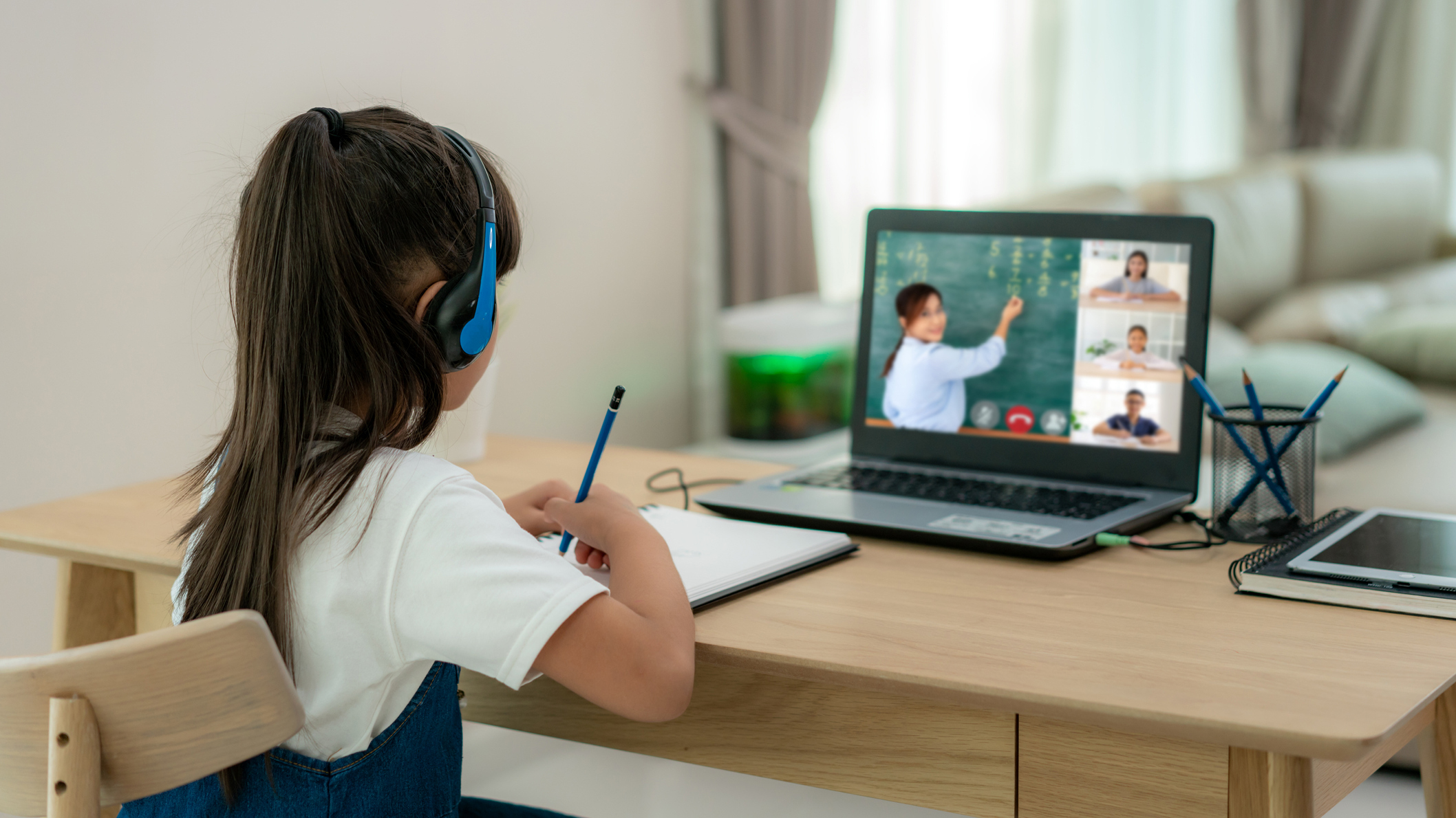 Young girl watching lessons on laptop
