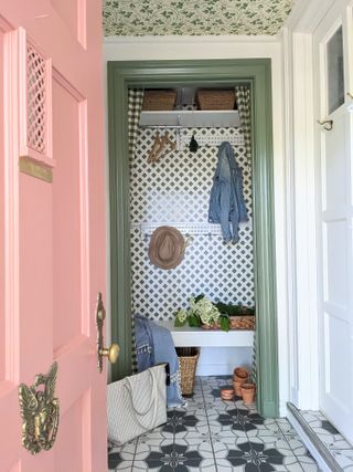 Mini mudroom makeover with pink door and green patterned wallpaper