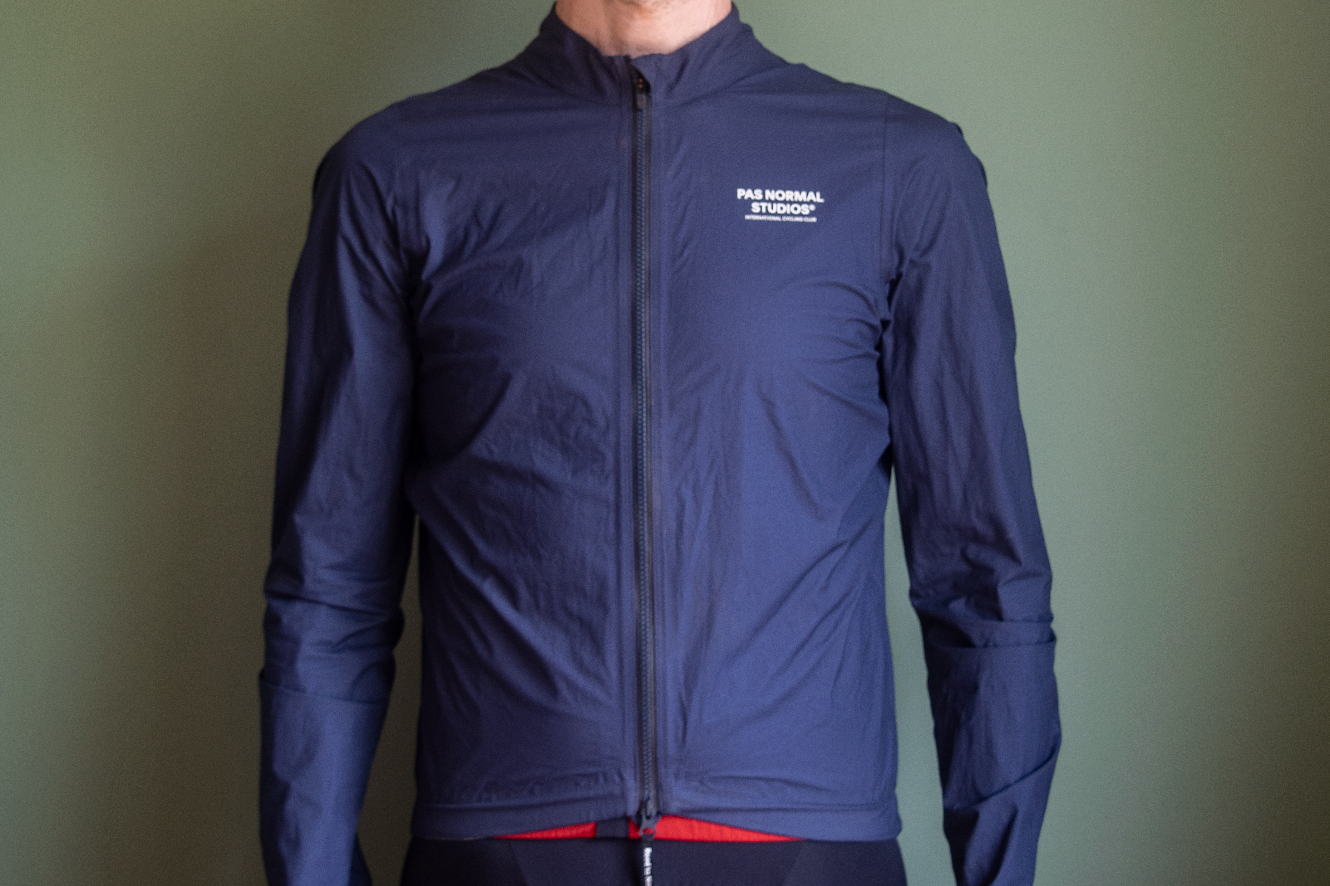 A man wearing a blue Pas Normal waterproof
