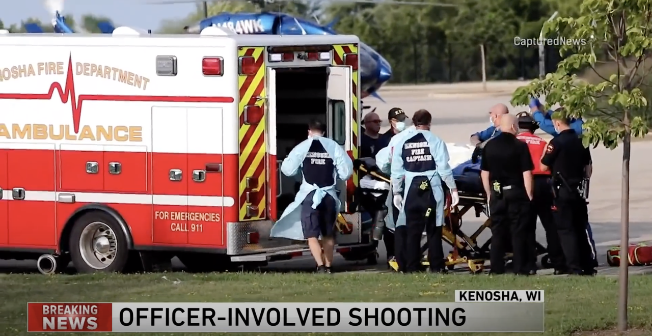 A shooting victim is put into an ambulance.