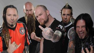 Five Finger Death Punch posing for a photograph in 2013