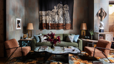 Velvet House Lounge by Dunnam Zerbini, featuring an artful rug, mural wall hanging, sculptural coffee table, and furniture upholstered with couture-grade fabrics.