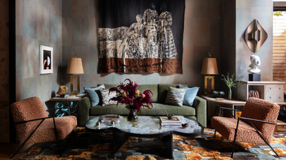 Velvet House Lounge by Dunnam Zerbini, featuring an artful rug, mural wall hanging, sculptural coffee table, and furniture upholstered with couture-grade fabrics.