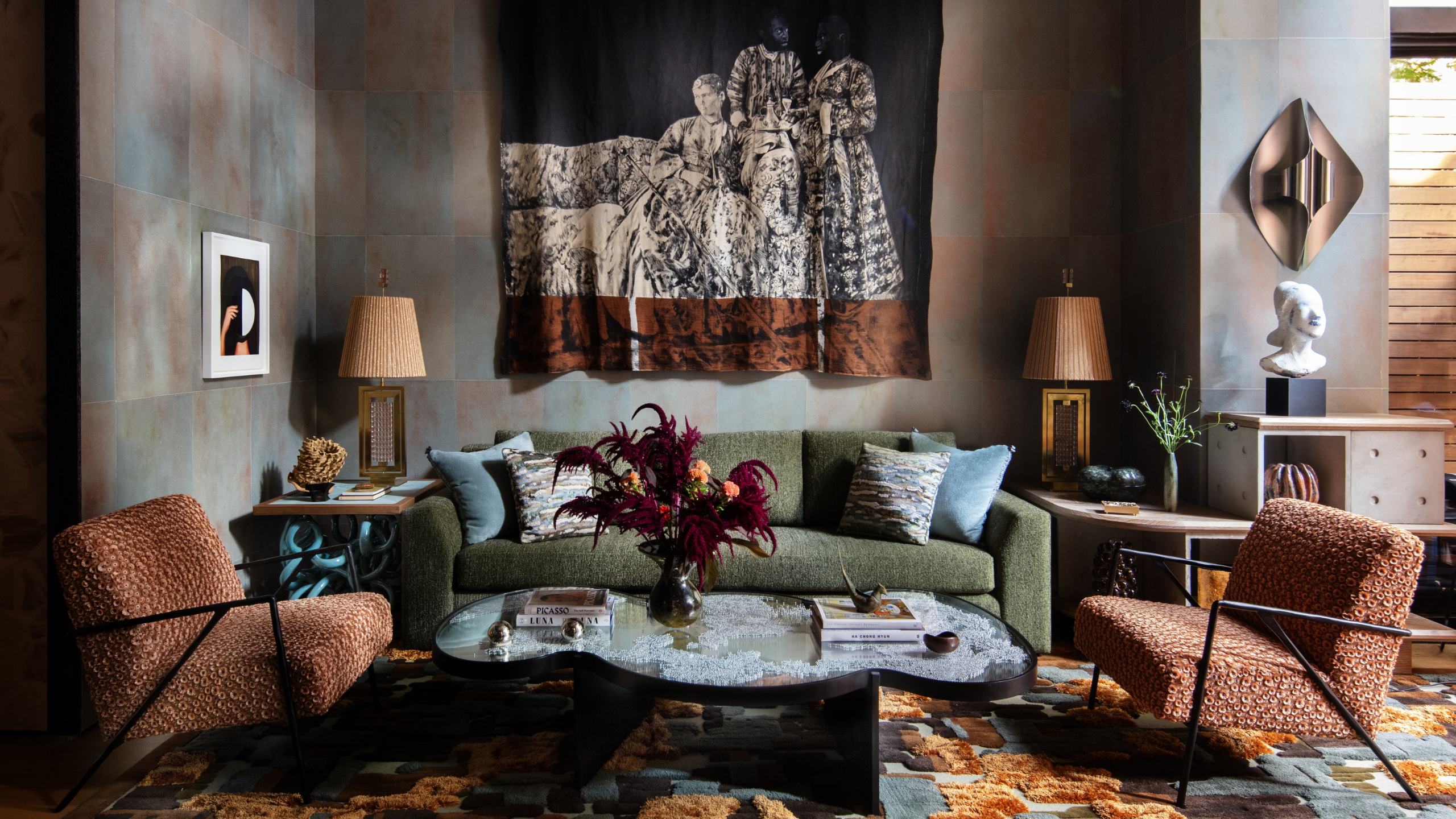Velvet House Lounge by Dunnam Zerbini, featuring an artful rug, mural wall hanging, sculptural coffee table, and furniture upholstered with couture-grade fabrics.