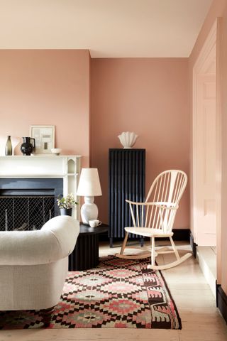 Living room with walls painted in pinky peach and ceiling in lighter nude shade