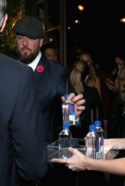 A different Fiji Water Lady serves guests at the HFPA’s and InStyle&amp;#039;s Celebration of the 2018 Golden Globe Awards Season.