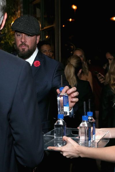 A different Fiji Water Lady serves guests at the HFPA’s and InStyle's Celebration of the 2018 Golden Globe Awards Season.