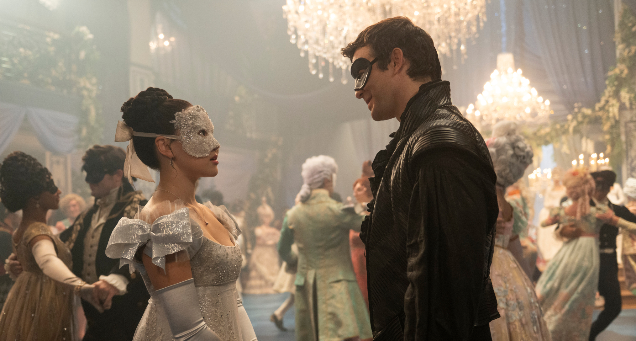 a woman and a man in masks look at each other at a ball in bridgerton season 4