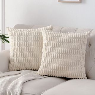 Cream colored, textured throw pillows on couch