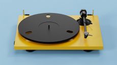 Pro-Ject E1.2 BT turntable in yellow on blue background