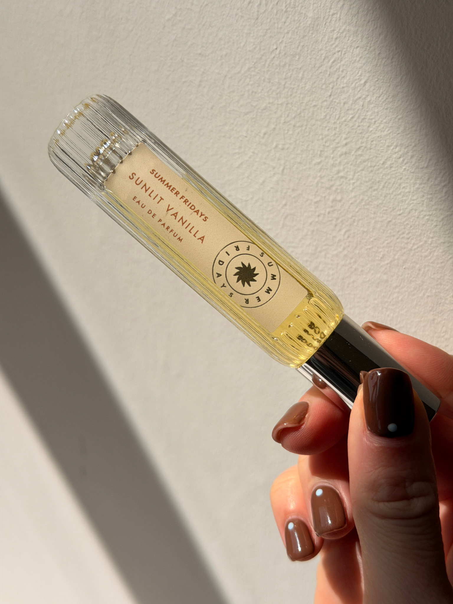 Beauty contributor Grace Day holding the Summer Fridays Sunlit Vanilla perfume