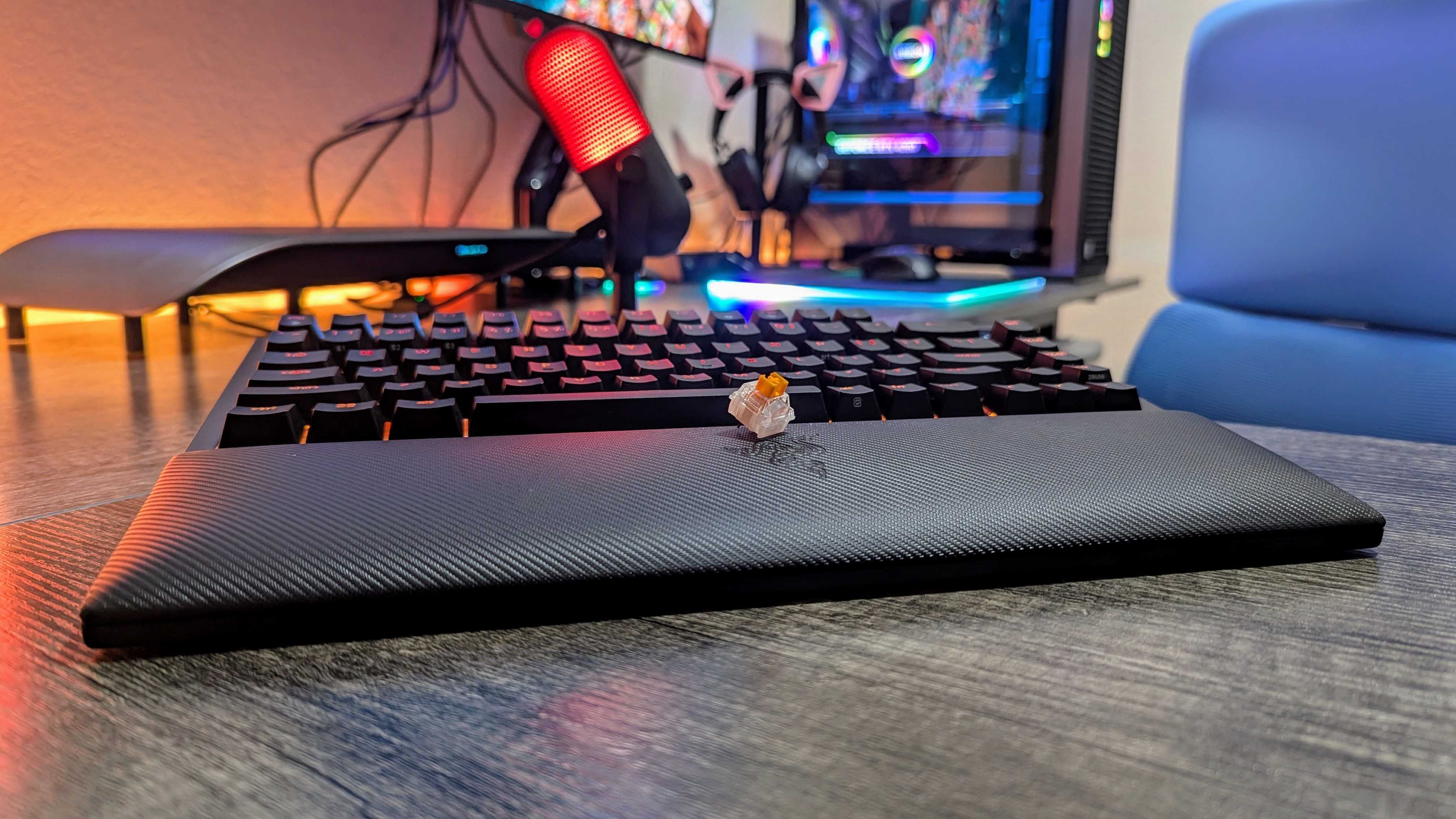 The Razer BlackWidow V4 Pro 75% with its wrist rest attached and a single Razer Orange switch on top.