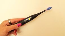 Oclean X Ultra S electric toothbrush being tested by our reviewer