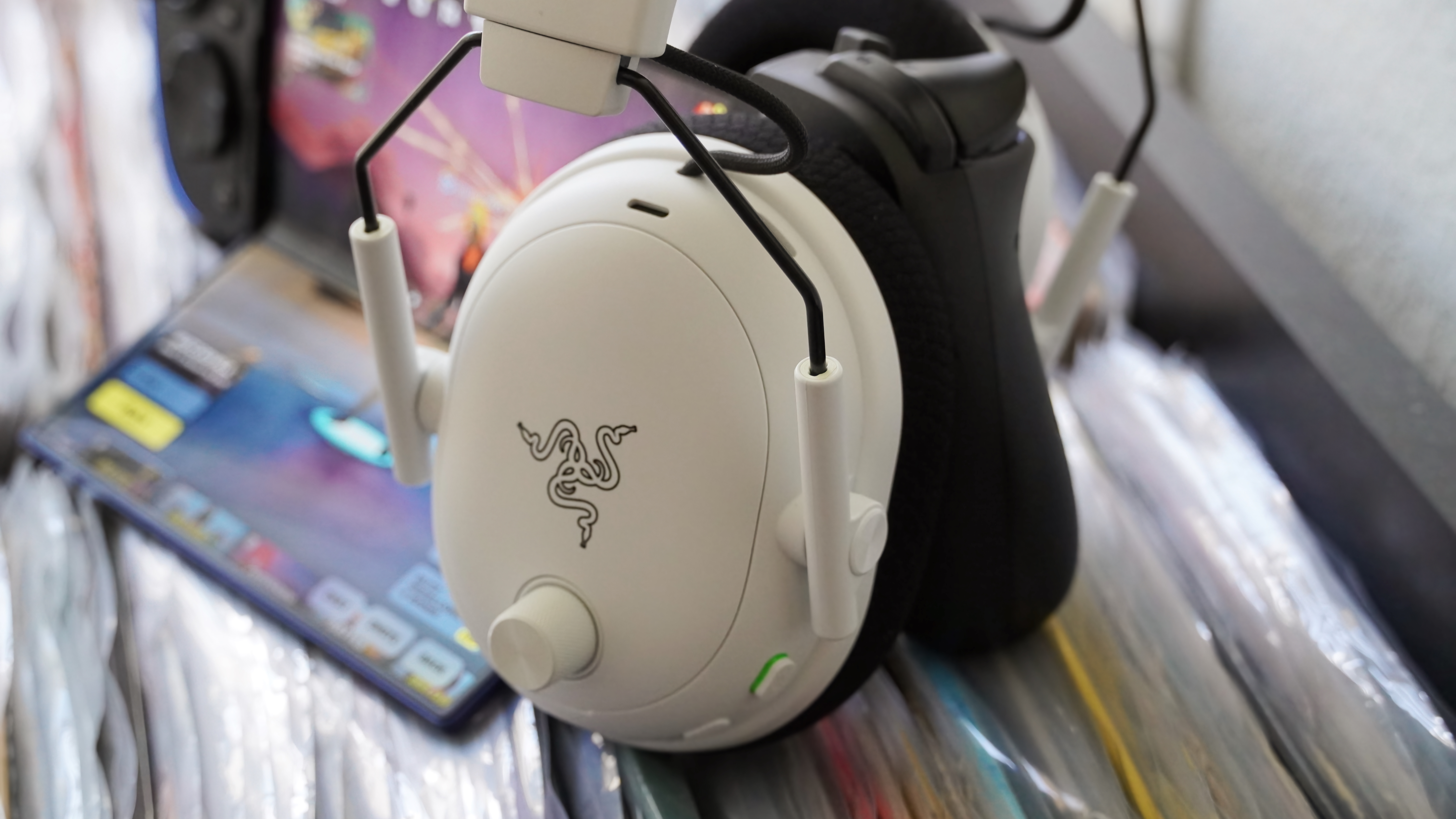 The Razer BlackShark V3 Pro gaming headset laid atop records with a Z Fold 7 in the background.