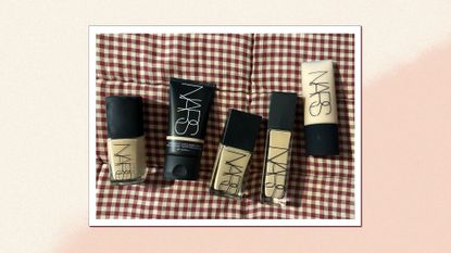 An image of all the NARS foundations on a gingham red throw