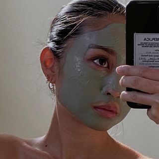 Woman with a clay face mask on