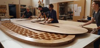 Snøhetta’s oval shaped Intersection Worktable made from Tasmanian Oak being constructed by the team