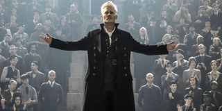 Johnny Depp as Gellert Grindelwald arms spread in front of crowd Fantastic Beasts: The Crimes of Gri