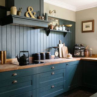 dark green kitchen with wall panelling