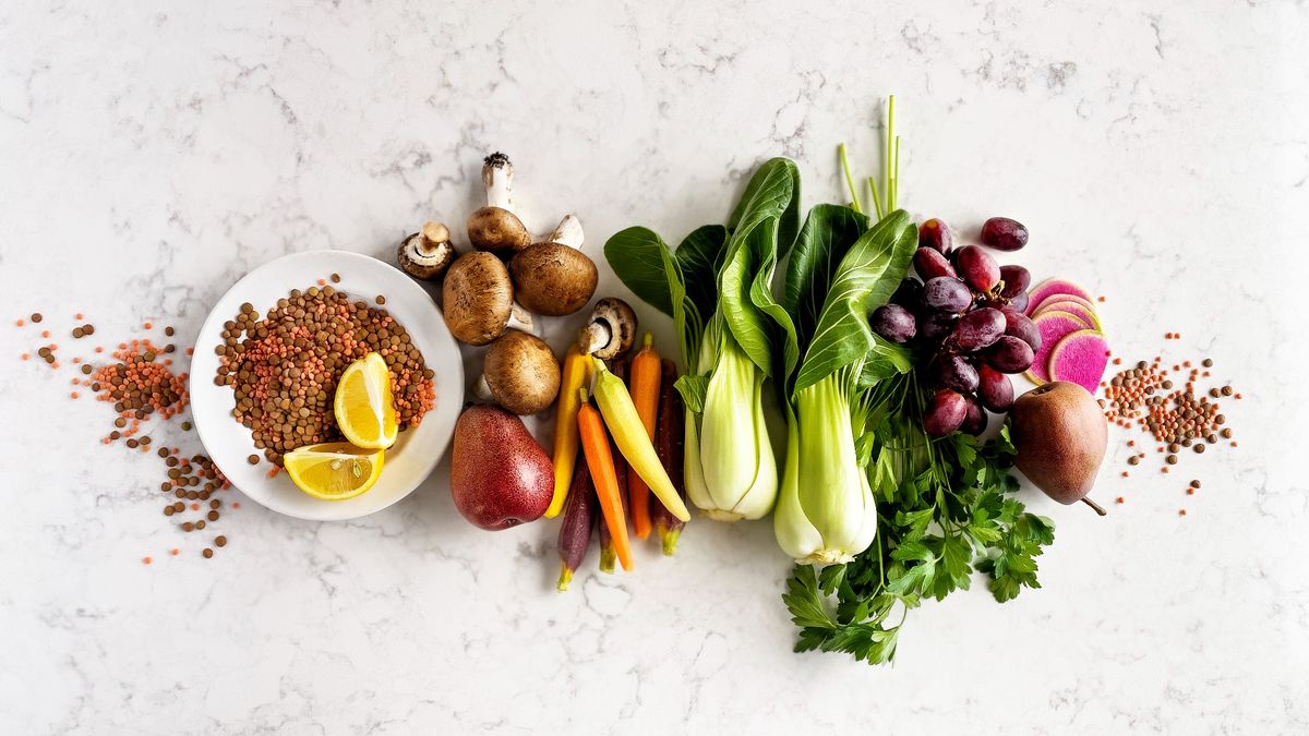 Selection of fruits and vegetables on white, marbled background