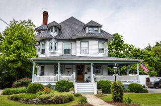 White Victorian house in America with a large porch