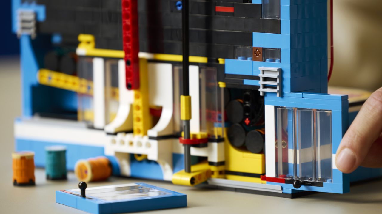 A hand pushes shut a rear compartment of the Lego Donkey Kong Arcade set