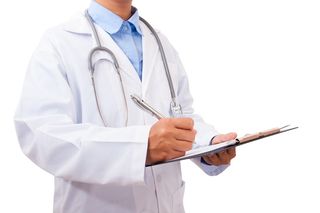 A doctor wearing a white coat with long sleeves