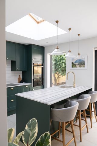 green kitchen with white marble worktop