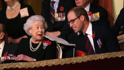 LONDON, ENGLAND - NOVEMBER 07: Queen Elizabeth II holds up her glasses after joking with Prince William, Duke of Cambridge in the Royal Box at the Royal Albert Hall during the Annual Festival of Remembrance on November 7, 2015 in London, England. (Photo by Chris Jackson - WPA Pool/Getty Images)