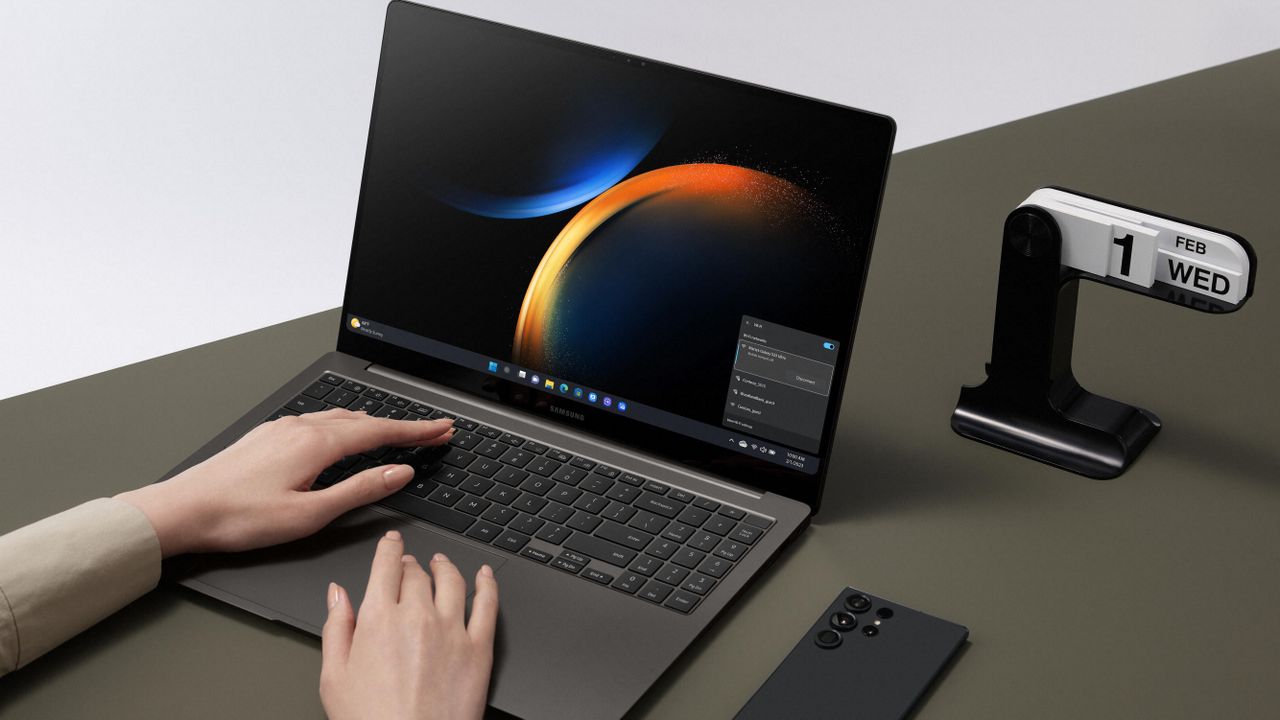 The Samsung Galaxy Book 3 Ultra, in graphite, in use on a black desk