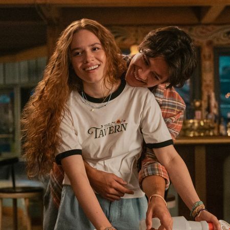 sam hugs percy from behind while she works a shift at the tavern in prime video's every year after