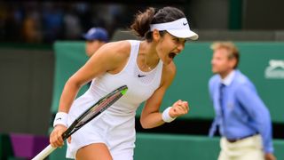 Emma Raducanu of Great Britain celebrates during her match against Sorana Cirstea of Romania in the third round of the ladies singles during Day Six of The Championships - Wimbledon 2021